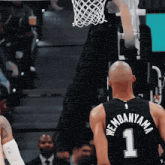 a basketball player wearing a black jersey with the number 1 on it