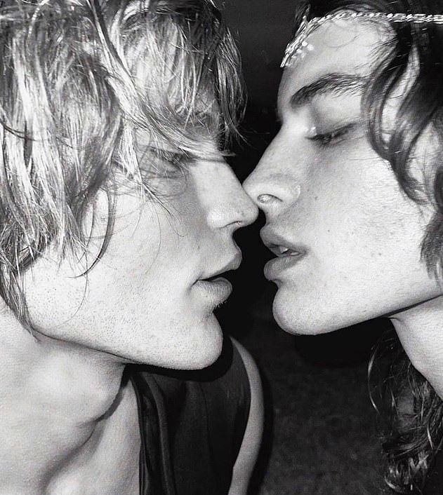 This may contain: two young men are kissing each other in black and white