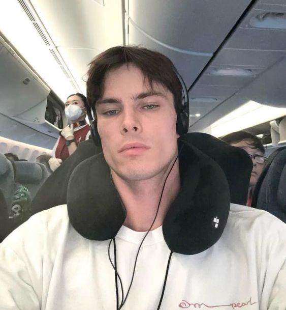 This may contain: a man wearing headphones on an airplane