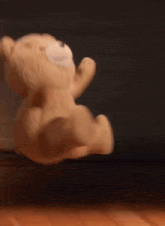 a teddy bear is jumping in the air .