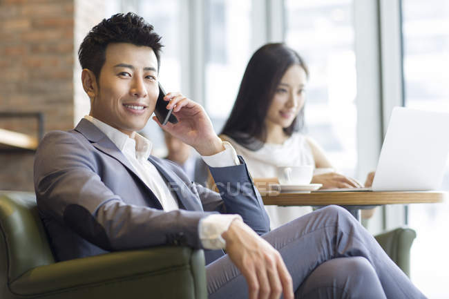 focused_184808456-stock-photo-chinese-man-talking-phone-woman.jpg