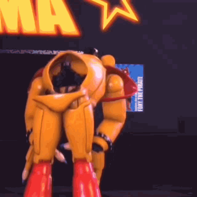 a yellow robot with red boots is kneeling down in front of a sign that says ma .