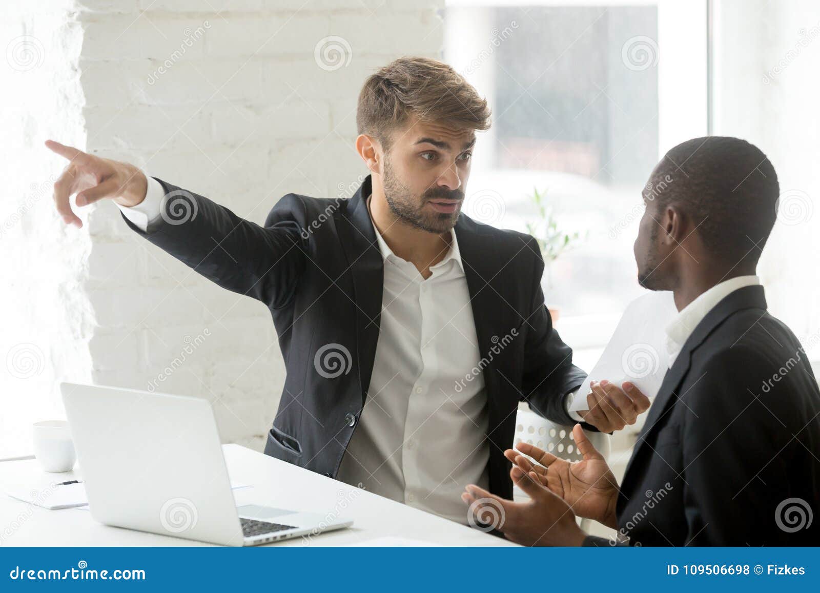 angry-rude-caucasian-executive-firing-male-incompetent-african-employee-bad-work-impolite-white-partner-telling-black-109506698.jpg