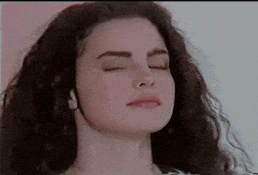 a close up of a woman 's face with eyes closed