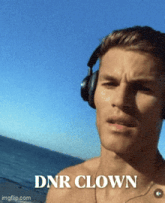 a shirtless man wearing headphones with the words dnr clown written below him