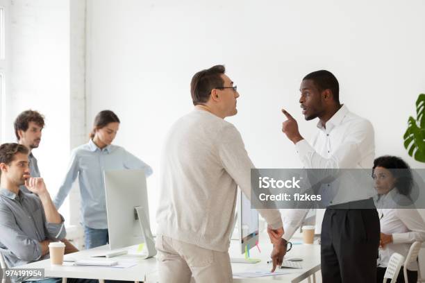 angry-black-worker-disputing-with-older-caucasian-colleague.jpg