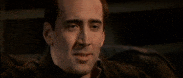 a close up of a man with his hand on his chin