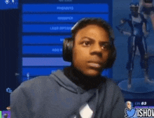 a young man wearing headphones is smiling in front of a screen that says  promote 