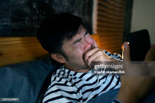 asian-man-young-adult-feeling-worried-and-concerned-after-use-smartphone-on-the-bed.jpg