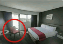a hotel room with a bed and a chair