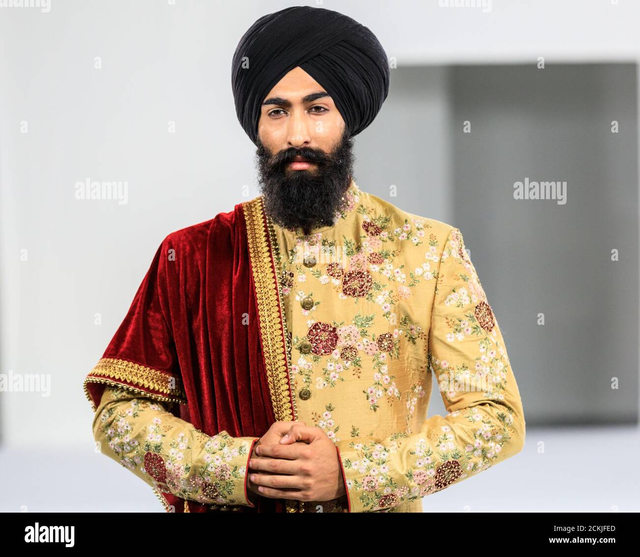 sikh-asian-male-model-groom-in-gold-coloured-wedding-suit-national-asian-wedding-show-fashion-runway-london-2CKJFED.jpg