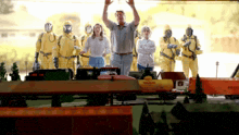 a man in a gas mask stands in front of a train set that says reefer