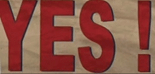 a sign that says yes in red letters on a beige background
