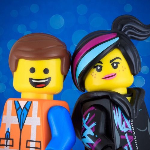This may contain: two legos are standing next to each other on a blue and white background with bubbles