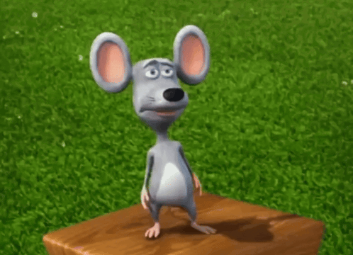 a cartoon mouse standing on a wooden block in the grass