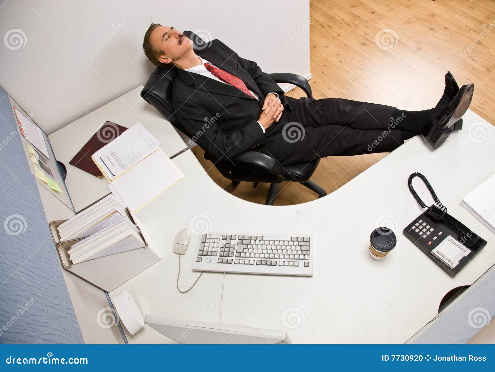 businessman-sleeping-desk-feet-up-7730920.jpg