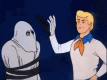 scooby doo and a ghost are standing next to each other in a dark room .