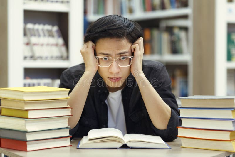 stressed-chinese-guy-preparing-exam-library-studying-too-much-tired-asian-student-specs-grabbing-his-head-exams-trying-to-172755764.jpg