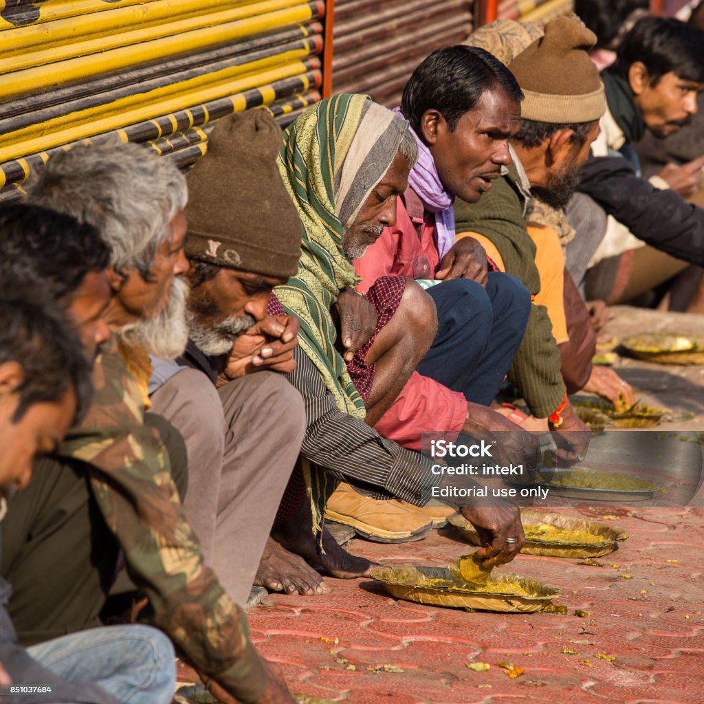 poor-indian-people-eating-free-food-at-the-street-in-varanasi-india.jpg