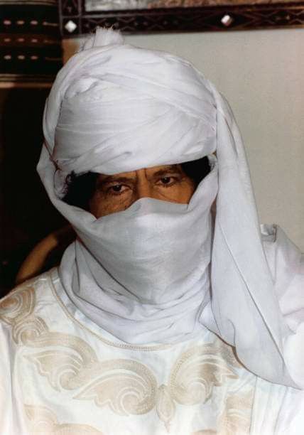 This may contain: an old woman wearing a white head covering