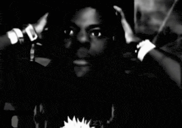 a black and white photo of a man with his hands on his head