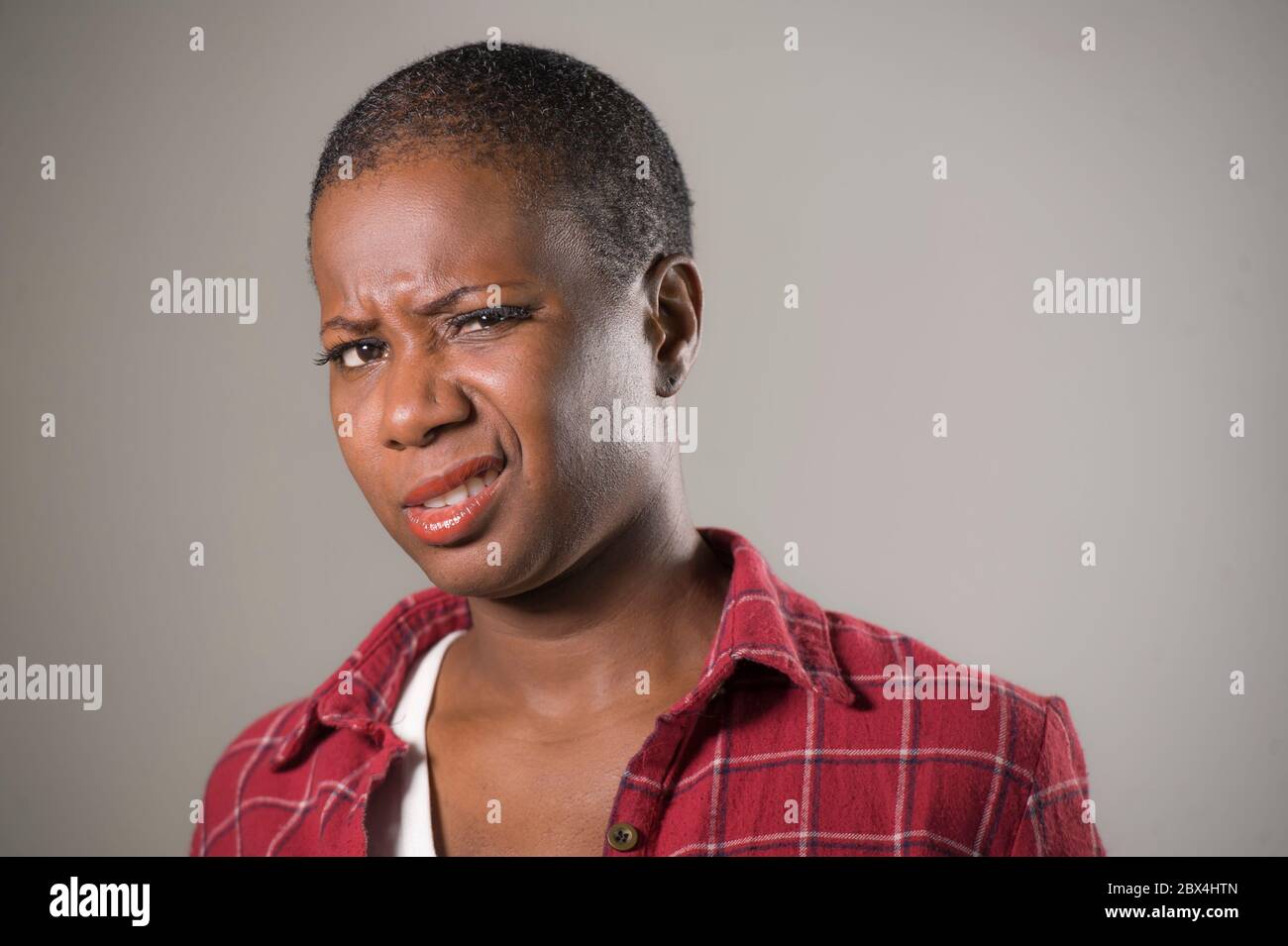 lifestyle-portrait-if-young-unhappy-and-pretty-afro-american-woman-in-contempt-and-disgust-face-expression-as-if-disliking-or-finding-disgusting-isola-2BX4HTN.jpg