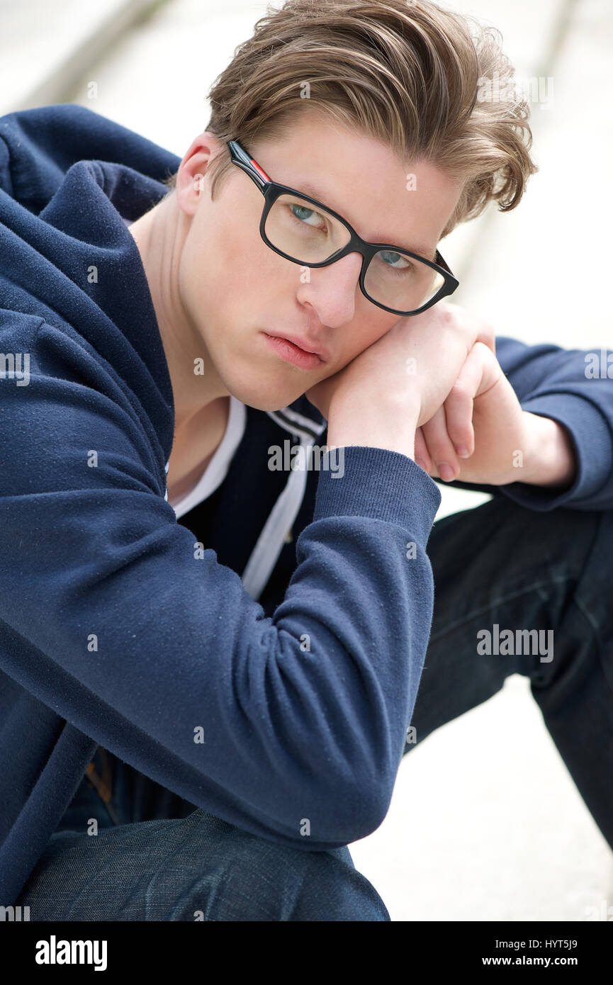 close-up-portrait-of-a-handsome-young-man-with-glasses-HYT5J9.jpg
