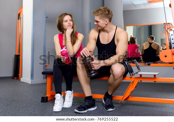 muscular-guy-athletic-girl-gym-600w-769255522.jpg