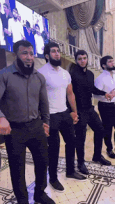 a group of men are standing in front of stairs
