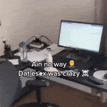 a computer monitor sits on a desk with the words  ain no way dat esex was crazy 