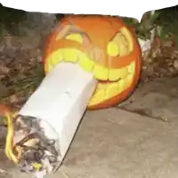 a pumpkin carved to look like a cigarette with a smile on its face