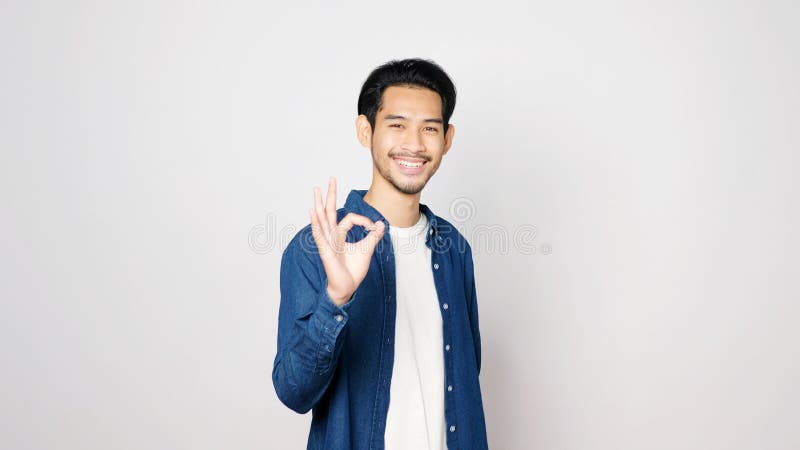 young-asian-man-showing-ok-hand-sign-smiling-standing-over-isolated-grey-background-happy-asia-male-showing-ok-hand-po-208007420.jpg