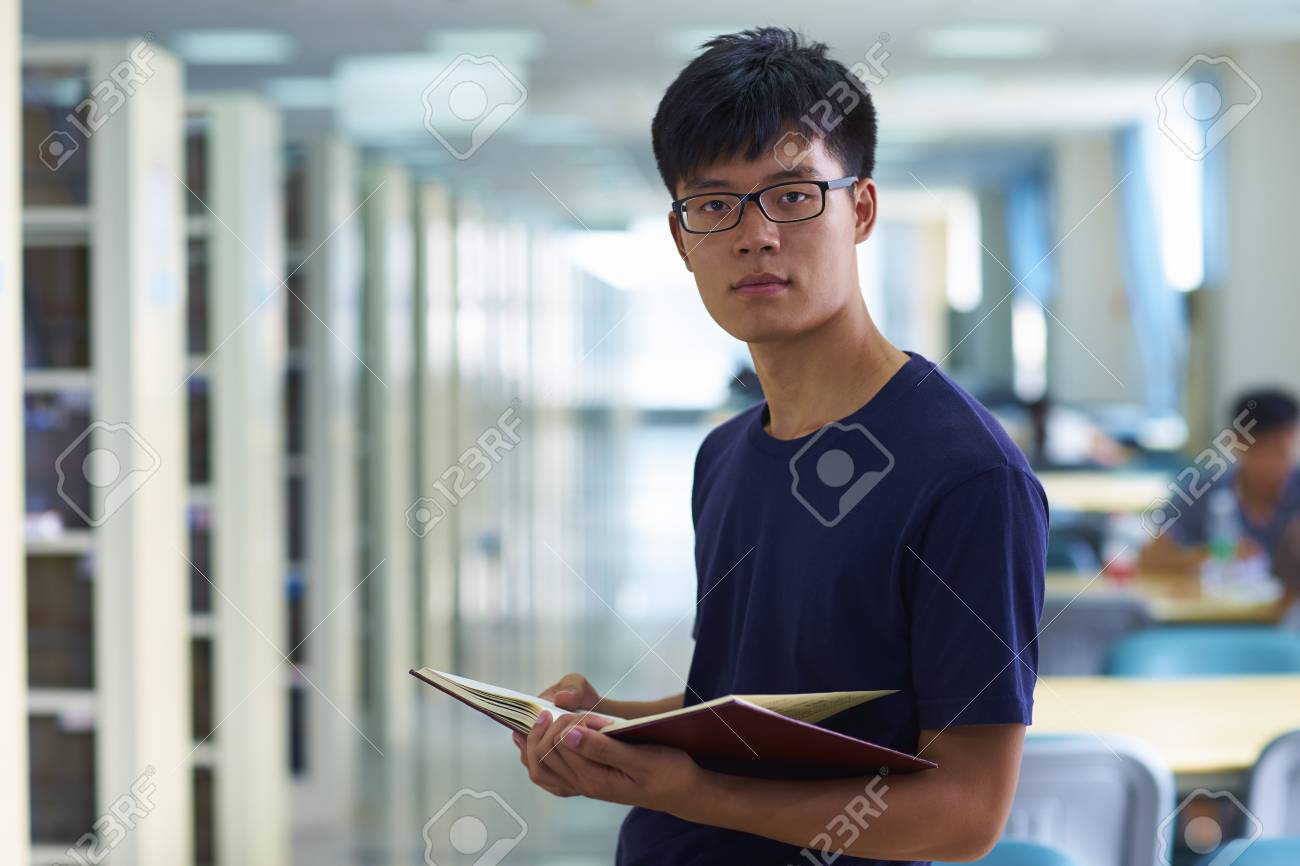 71815322-one-young-male-asian-or-chinese-college-students-looking-at-camera-smile-in-the-library.jpg