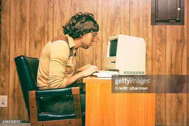 funny-nerdy-man-looking-intensely-at-vintage-computer.jpg