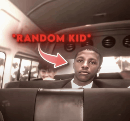 a man in a suit sits in the back seat of a bus with a red arrow pointing to random kid