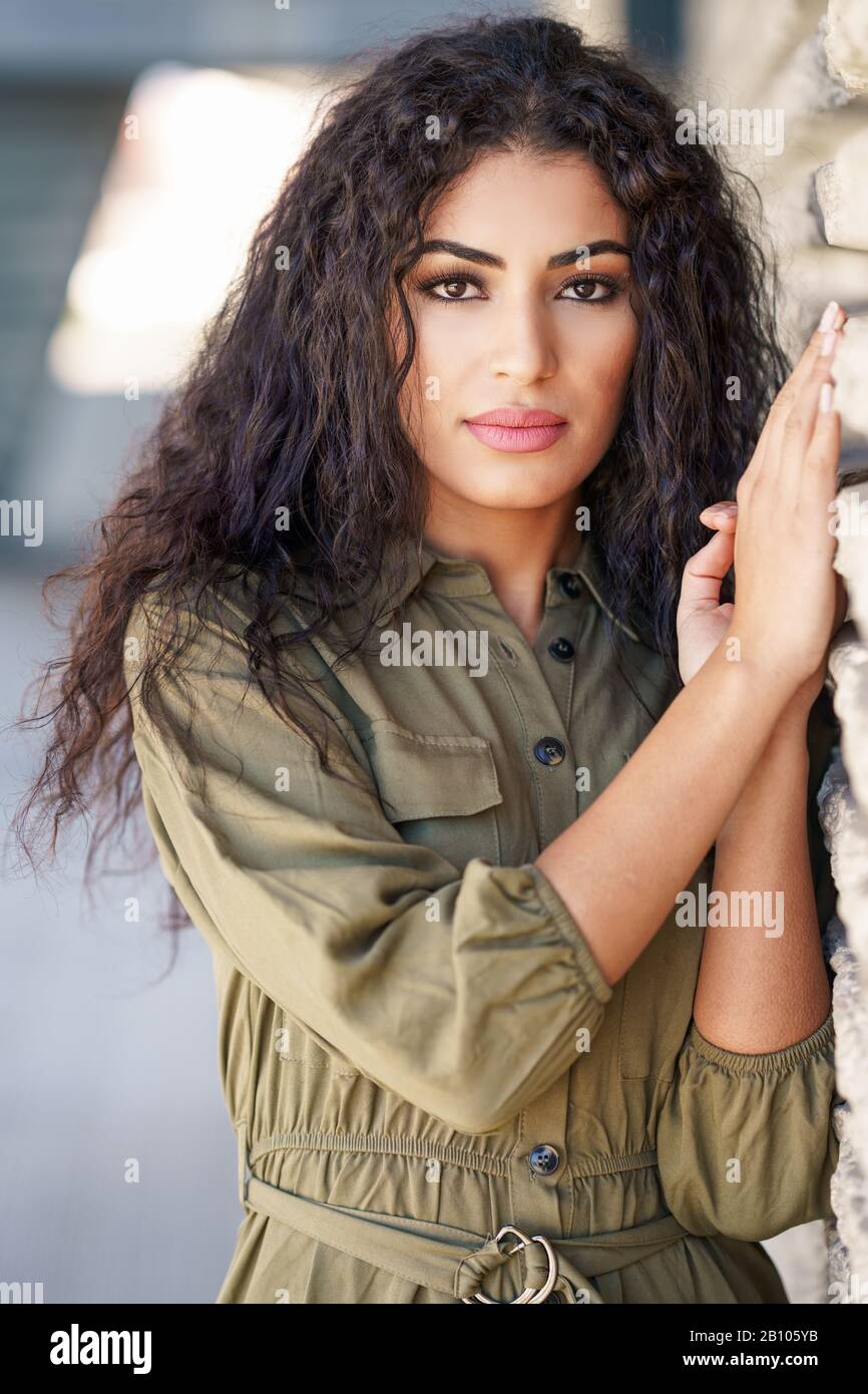 young-arab-woman-with-curly-hair-outdoors-2B105YB.jpg