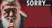 a man with a beard and red eyes is holding his finger to his mouth and says sorry