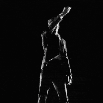 a man with a ring on his finger looks down