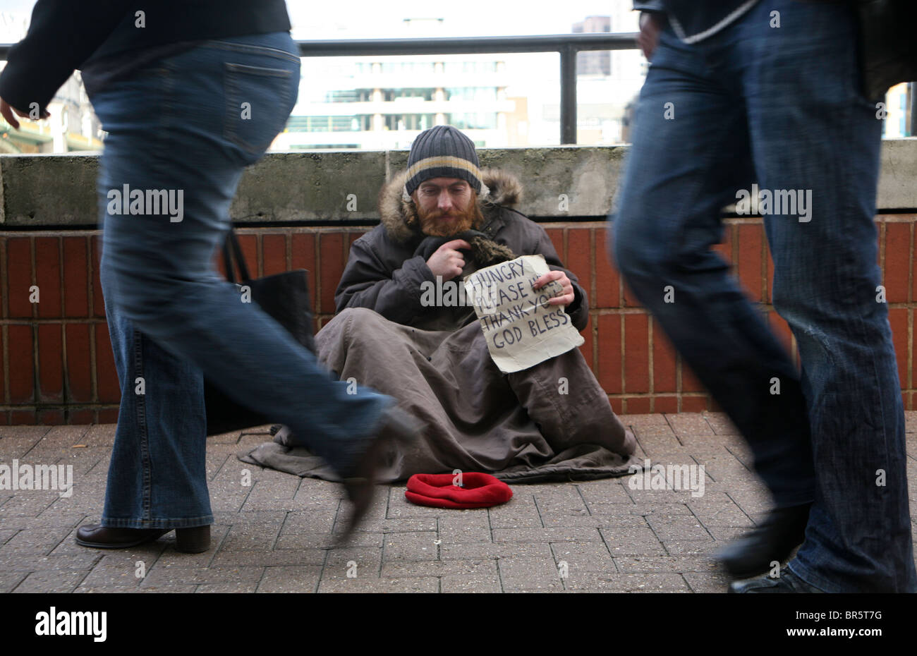people-passing-a-homeless-man-begging-for-money-london-BR5T7G.jpg