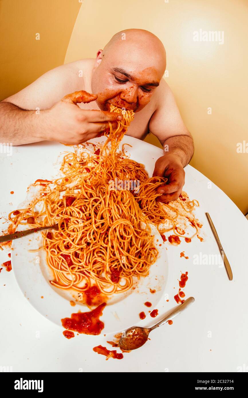 photo-of-an-overweight-bald-man-enjoying-a-plate-of-spaghetti-shot-with-fish-eye-lens-2C32714.jpg