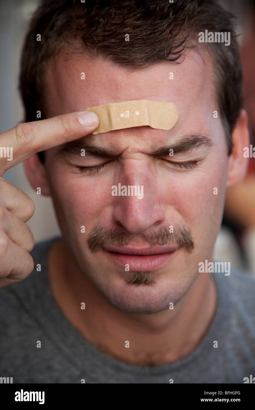 young-man-with-an-adhesive-bandage-on-forehead-BFHGFG.jpg