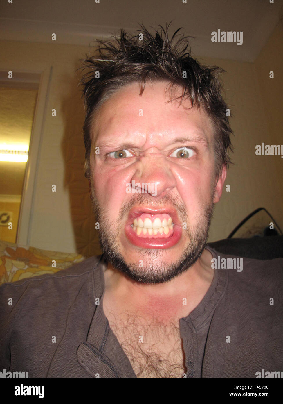 An angry face of a man bearing his teeth Stock Photo - Alamy