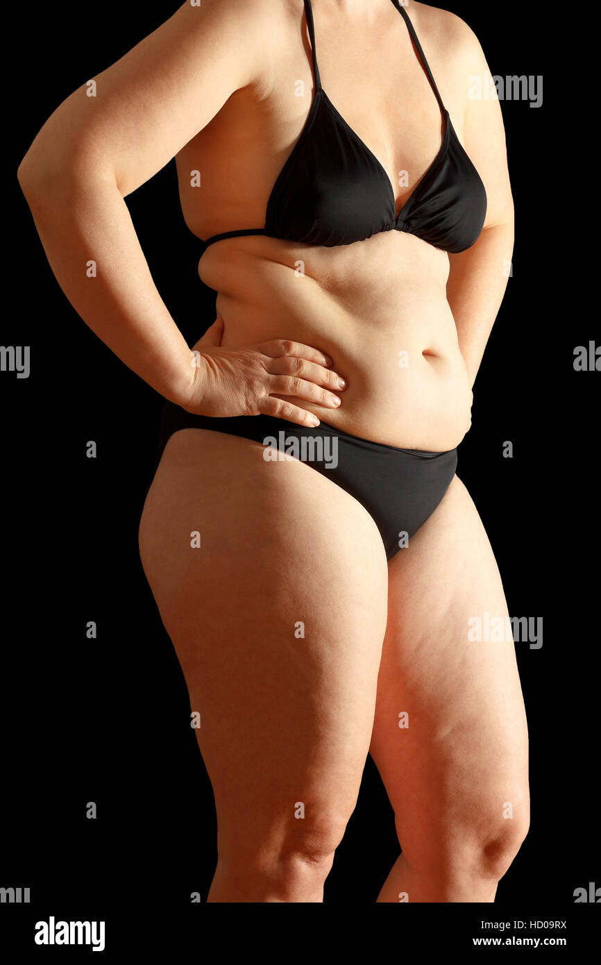 body-of-a-middle-aged-woman-in-bikini-with-excessive-fat-on-waist-and-thighs-dimpled-skin-black-background-HD09RX.jpg