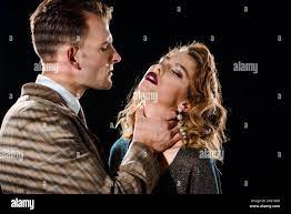 dangerous gangster choking attractive woman isolated on black Stock Photo -  Alamy