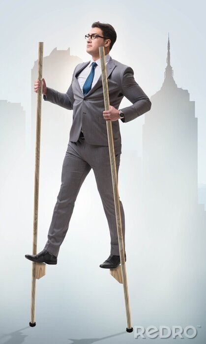 businessman-walking-on-stilts-standing-out-from-the-crowd-700-271435446.jpg