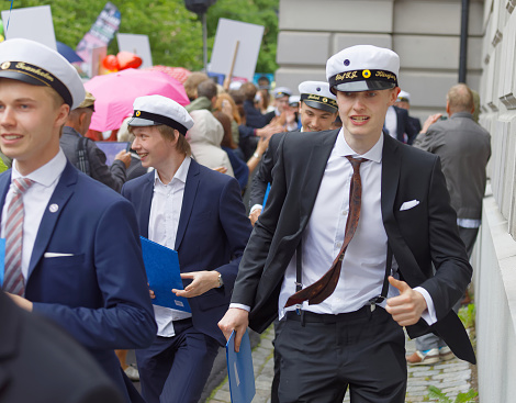 happy-swedish-male-students-in-suits-running-out-from-school-after-picture-id866735076