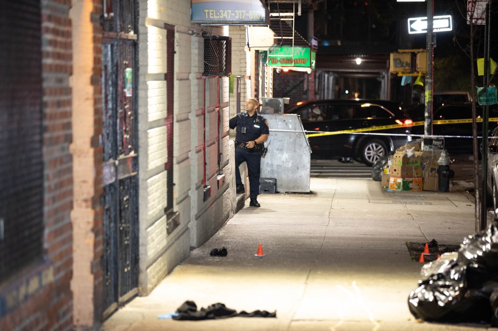 A police officer is seen at the scene of a shooting on Morris Ave.