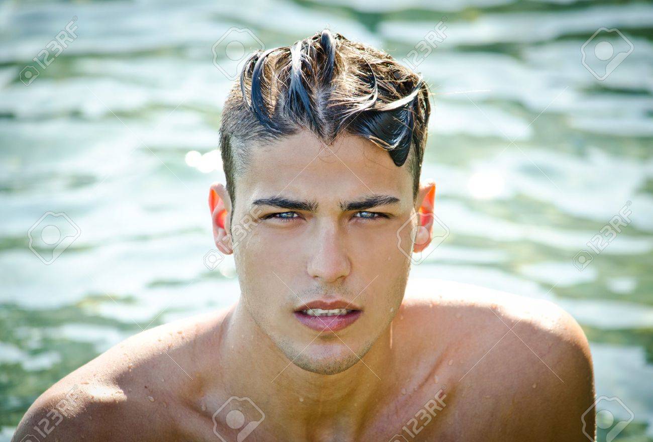 21053903-attractive-young-man-in-the-sea-getting-out-of-water-with-wet-hair-looking-in-camera.jpg