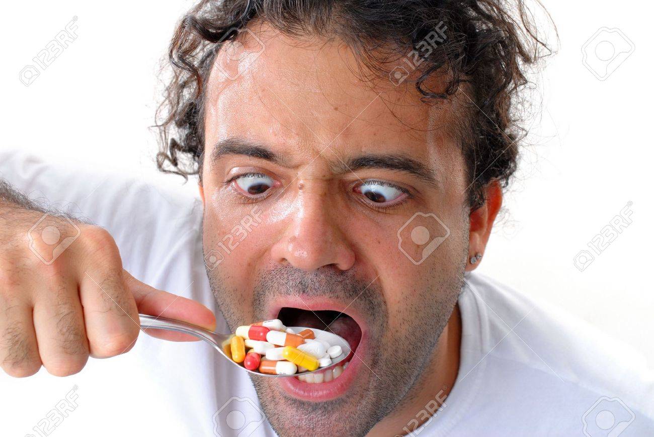2632206-man-eating-pills-with-a-spoon-self-medication-.jpg