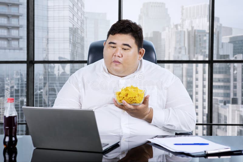 fat-man-eating-chips-working-his-office-portrait-asian-businessman-holding-laptop-cityscape-background-174324754.jpg